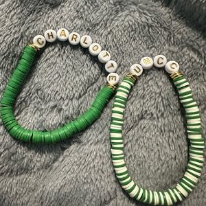 Two UNCC Charlotte beaded bracelets.